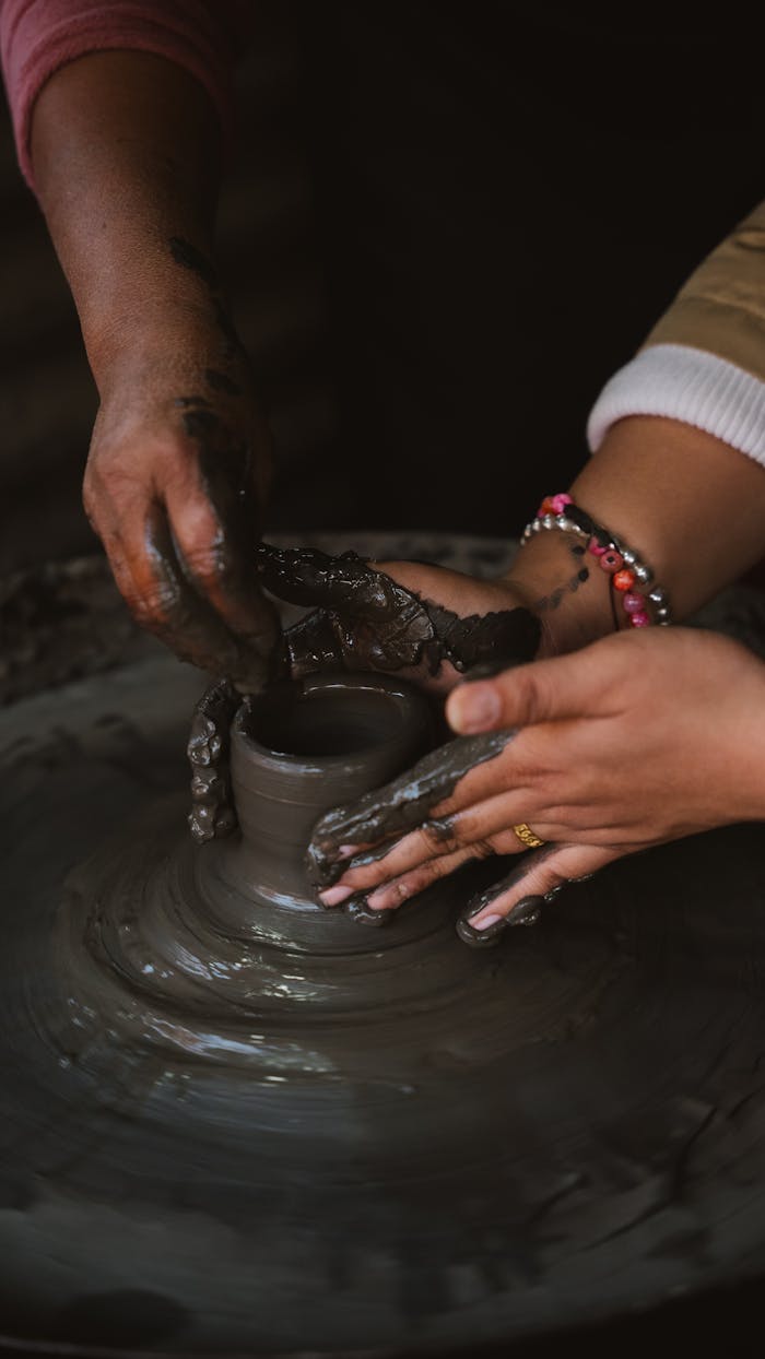 services-04 Close-up of artisans shaping clay pottery in Bhaktapur, Nepal.